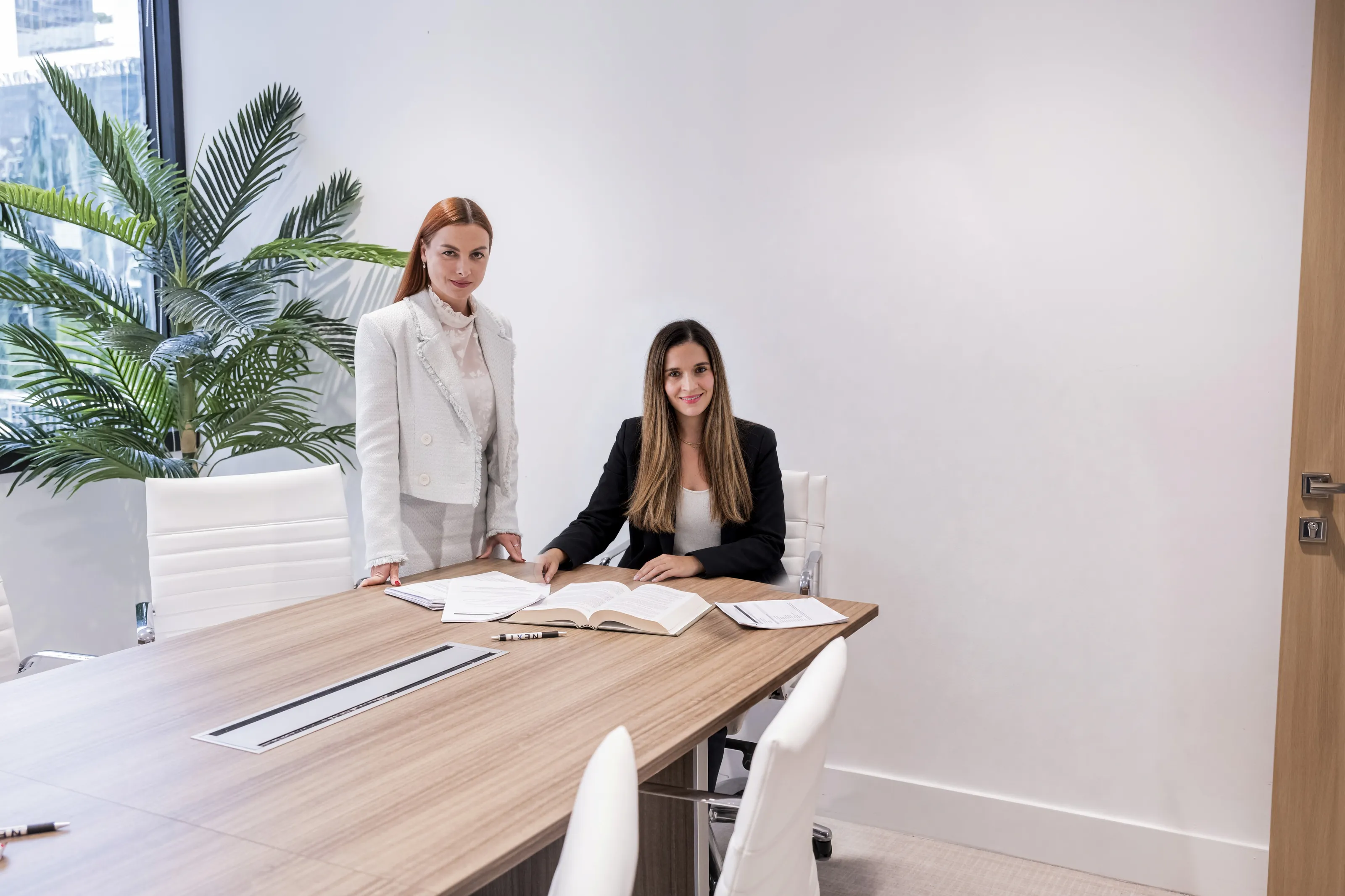 Two NEXT Legal lawyers at a conference table in the Miami office